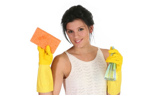 Cleaner preparing a safe work area with cleaning supplies